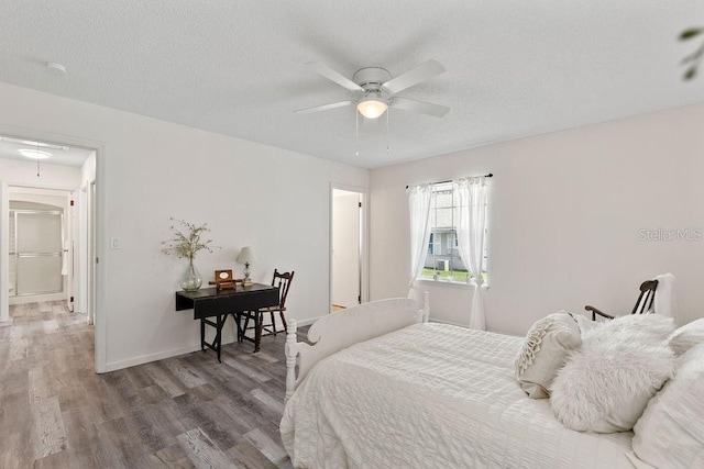 bedroom featuring a textured ceiling, hardwood / wood-style flooring, and ceiling fan