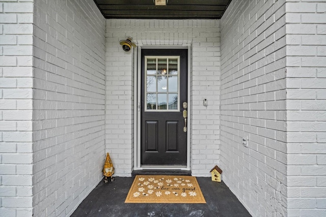 view of exterior entry with brick siding