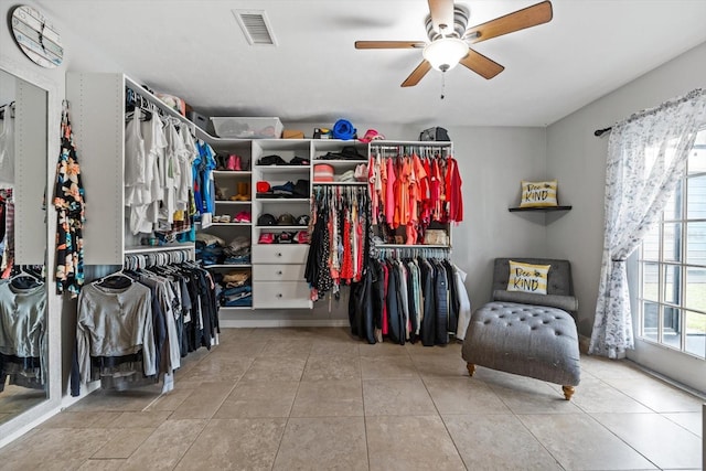 walk in closet featuring tile patterned flooring, visible vents, and a ceiling fan