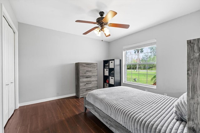 bedroom with ceiling fan, a closet, baseboards, and wood finished floors