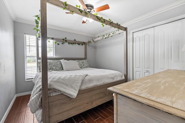 bedroom featuring ornamental molding, dark wood-type flooring, a closet, and baseboards