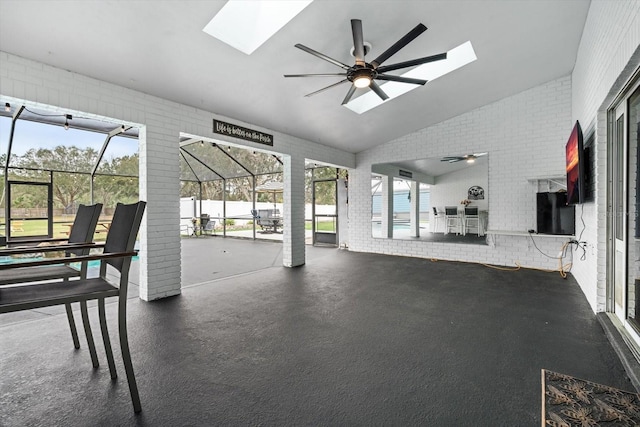 interior space with vaulted ceiling with skylight and ceiling fan