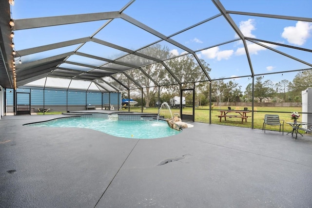 view of pool featuring a lanai, a patio area, a pool with connected hot tub, and a lawn