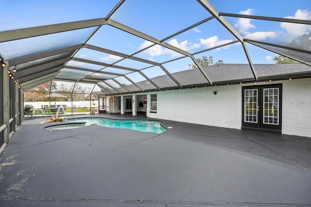 view of swimming pool with a fenced in pool, glass enclosure, an in ground hot tub, french doors, and a patio area