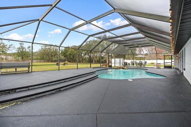 pool with glass enclosure and a patio