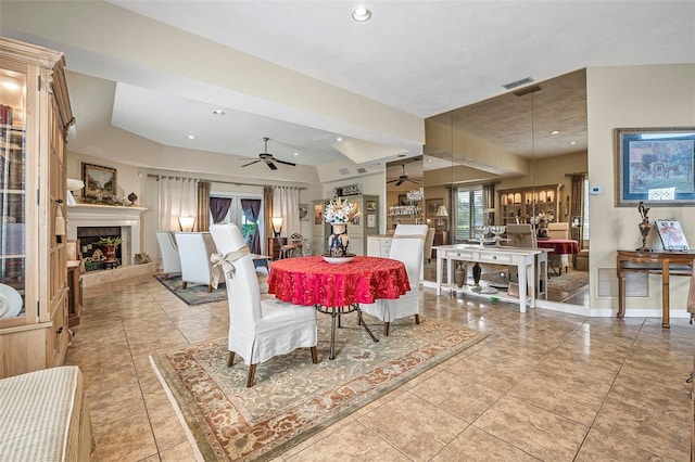 dining space with a ceiling fan, recessed lighting, a fireplace with raised hearth, and visible vents