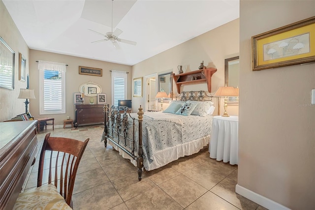 bedroom with ceiling fan, tile patterned flooring, and baseboards