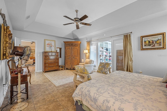 bedroom featuring ceiling fan, visible vents, a raised ceiling, and light tile patterned flooring