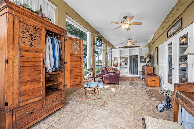 sunroom / solarium with a ceiling fan