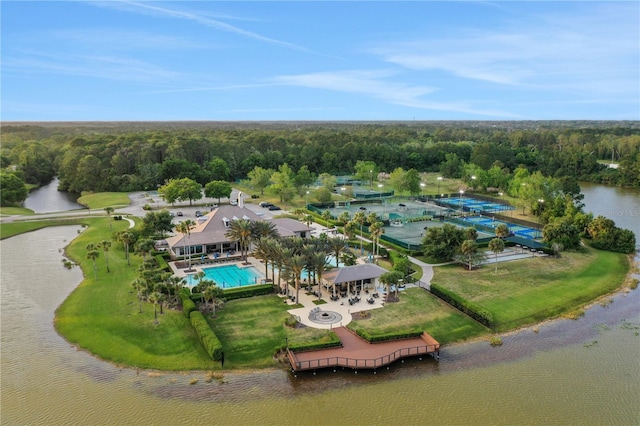 drone / aerial view featuring a water view and a wooded view