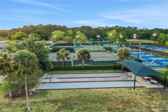 surrounding community featuring a tennis court, a lawn, and fence