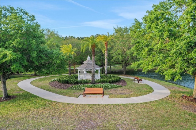 view of home's community with a water view, a yard, and a gazebo