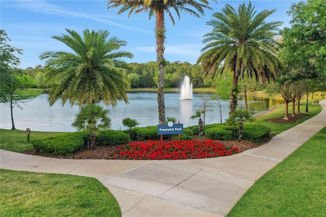 view of home's community featuring a water view and a lawn