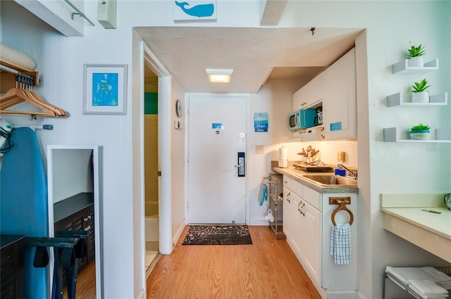 interior space with light wood-style floors and a sink