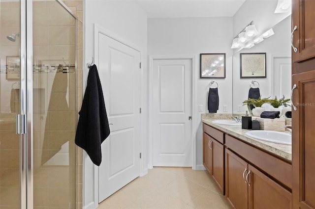 bathroom with tile patterned floors, a shower with door, and vanity