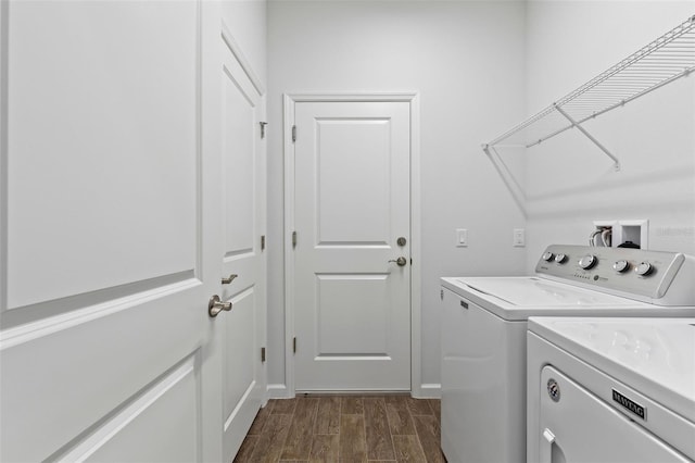 laundry area with dark wood-type flooring and washer and clothes dryer