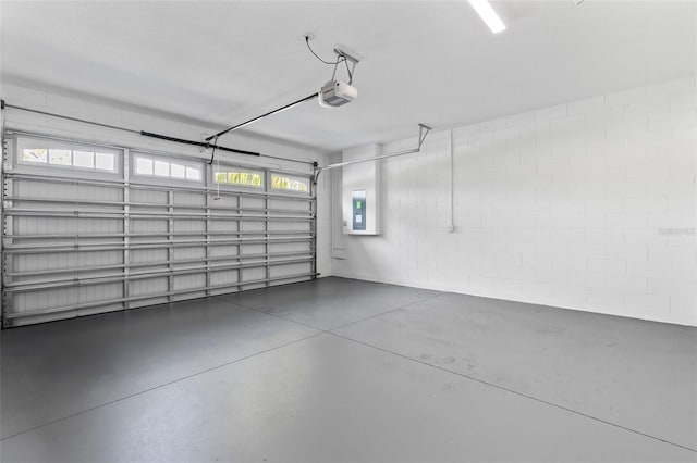 garage featuring electric panel and a garage door opener