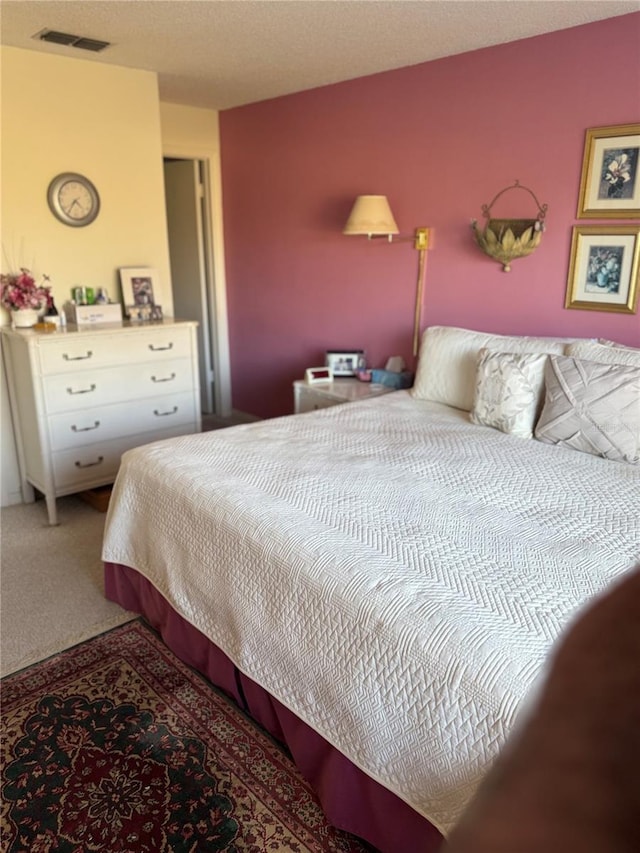carpeted bedroom featuring a textured ceiling