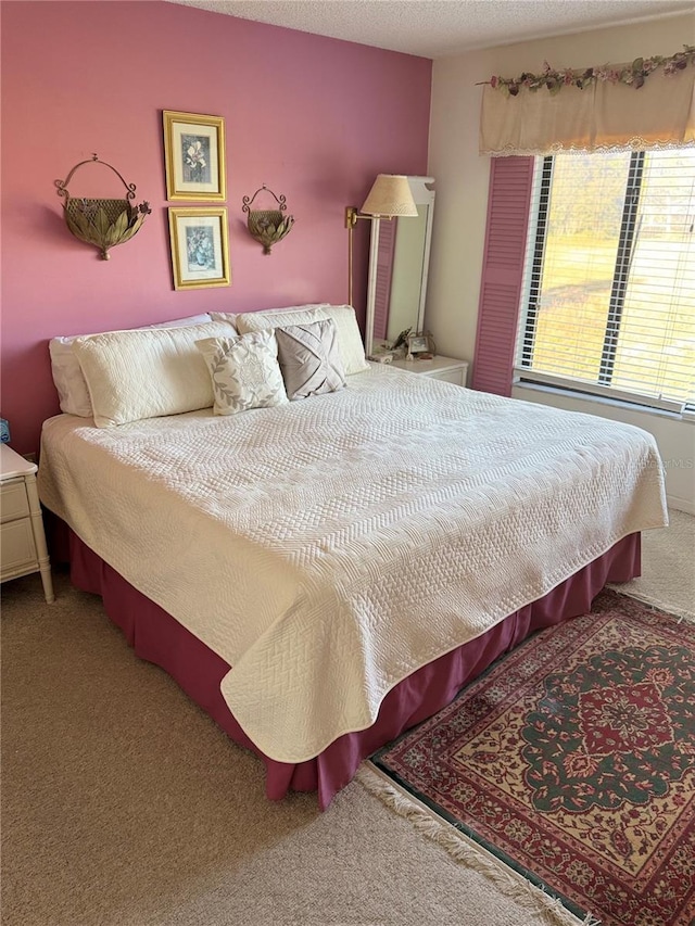 bedroom with carpet and a textured ceiling