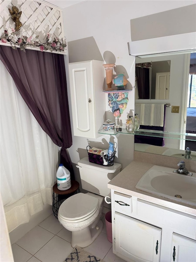 bathroom featuring toilet, tile patterned flooring, and vanity
