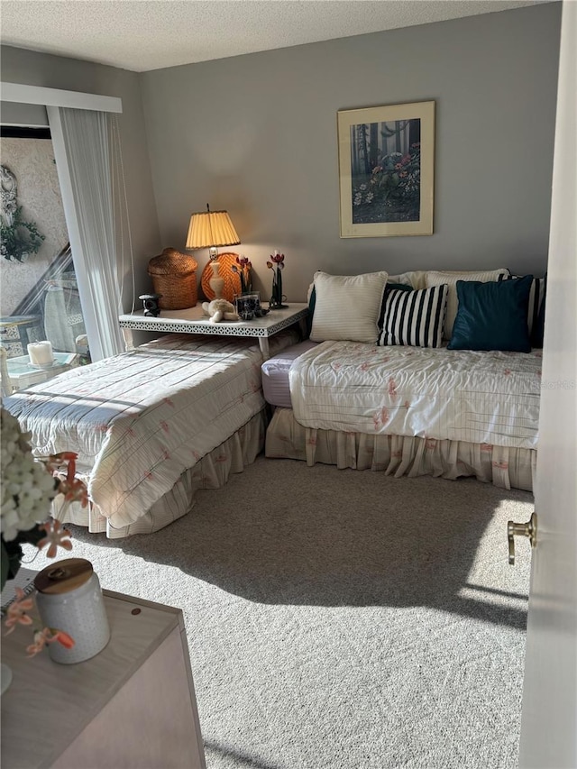 bedroom featuring a textured ceiling and carpet flooring