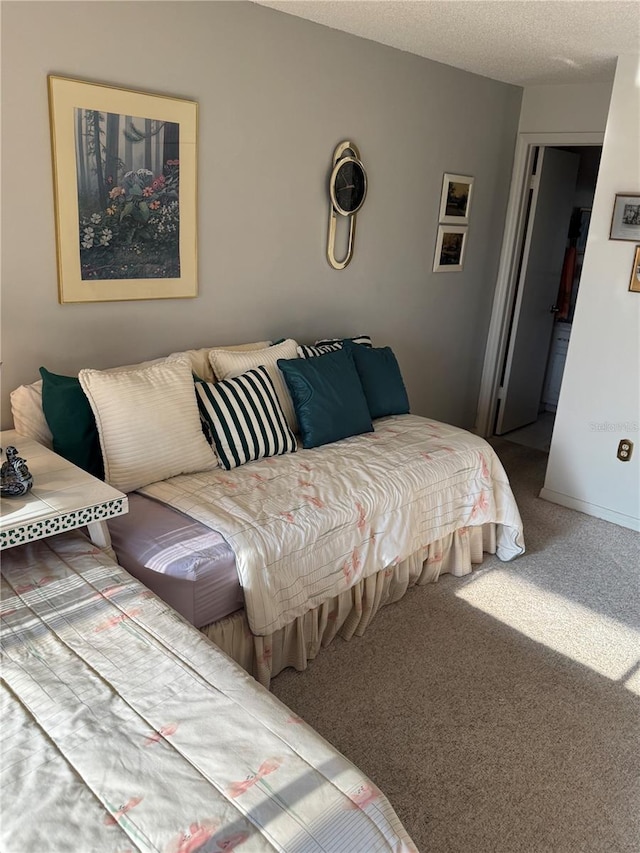 carpeted bedroom featuring a textured ceiling