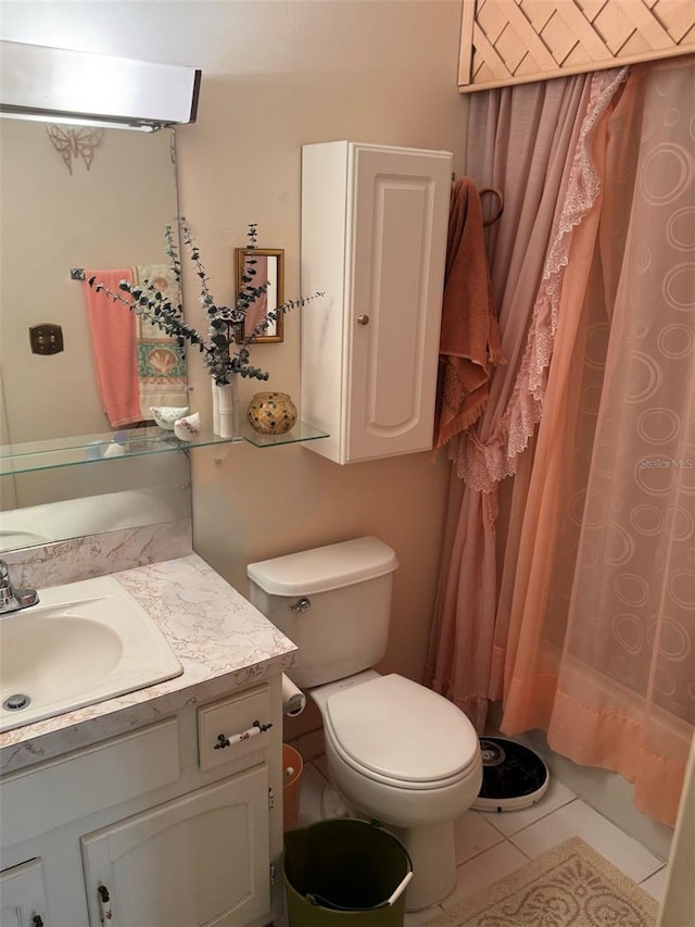 bathroom featuring tile patterned floors, toilet, and vanity