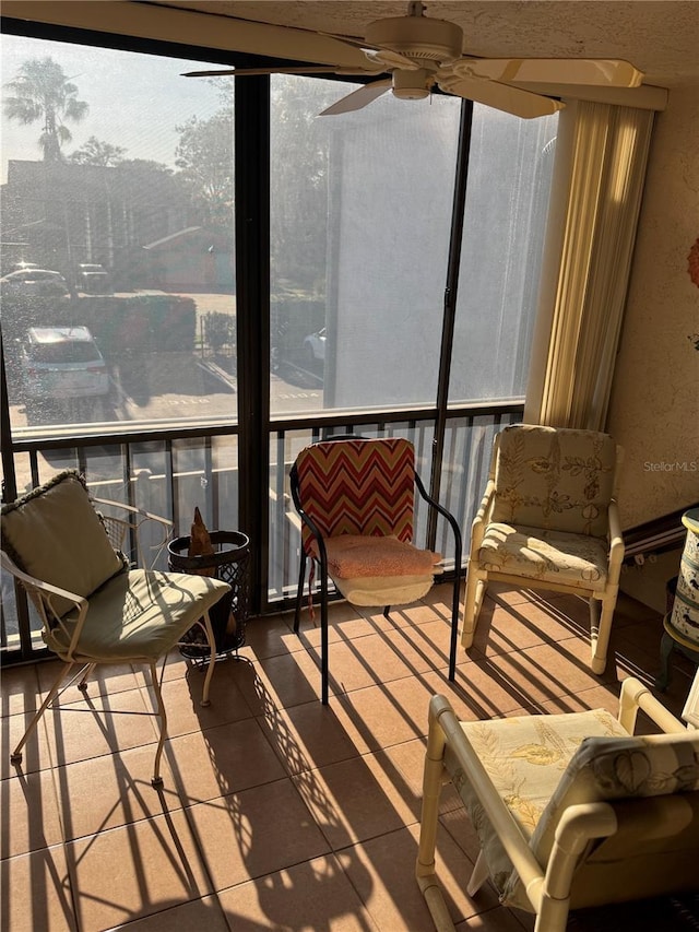 sunroom / solarium featuring ceiling fan