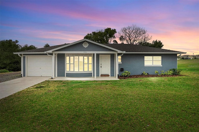 ranch-style house with an attached garage, a front lawn, and concrete driveway