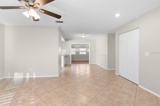 spare room with light tile patterned floors, baseboards, and visible vents