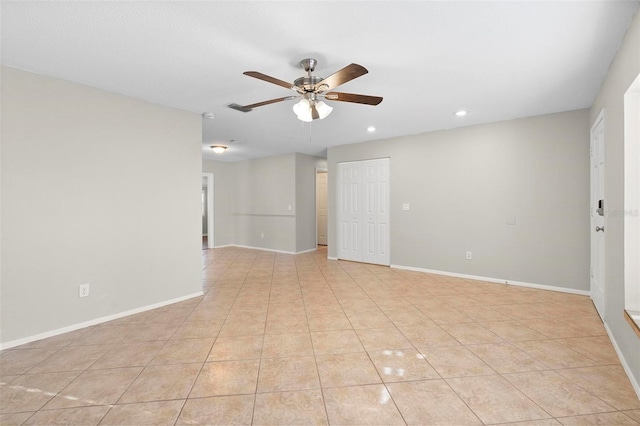 spare room featuring recessed lighting, light tile patterned flooring, a ceiling fan, and baseboards