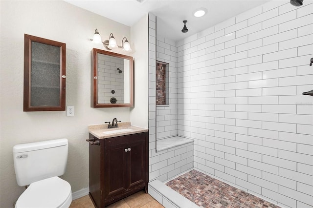 full bathroom with toilet, a shower stall, tile patterned flooring, and vanity