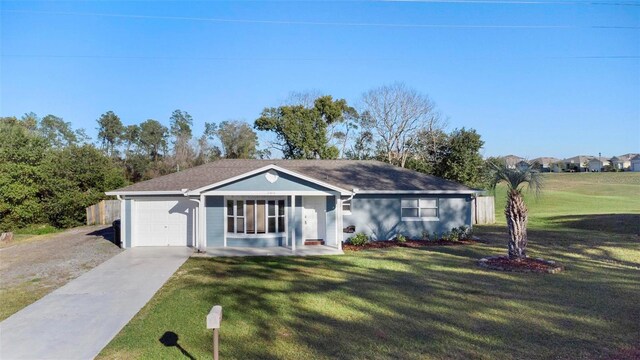 ranch-style house with an attached garage, a front lawn, and concrete driveway