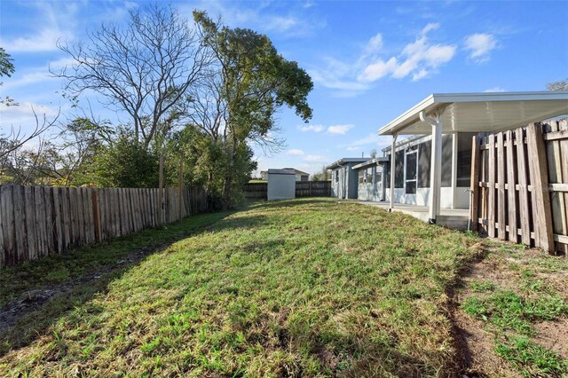 view of yard featuring a fenced backyard and a sunroom