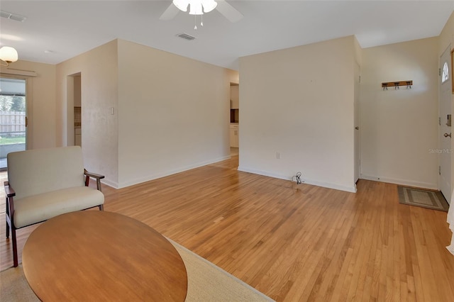 interior space featuring light wood-style floors, visible vents, and baseboards