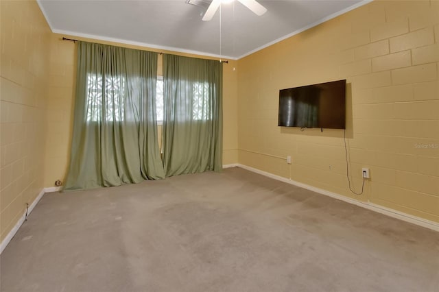 spare room with ceiling fan, carpet floors, and ornamental molding