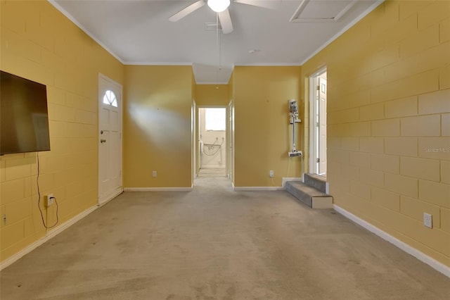 unfurnished living room with ornamental molding, light carpet, ceiling fan, and baseboards