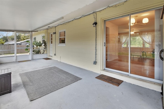 unfurnished sunroom with a ceiling fan