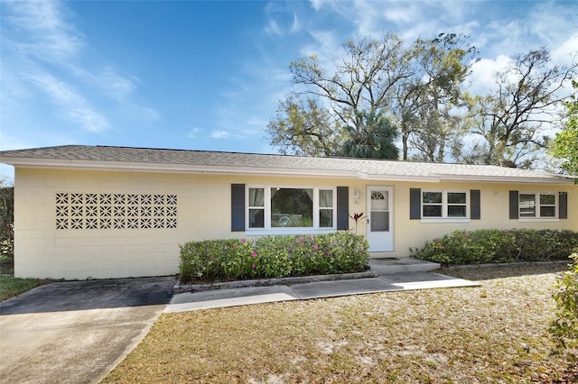 single story home featuring roof with shingles