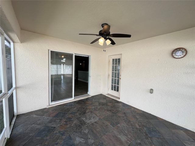 exterior space with ceiling fan