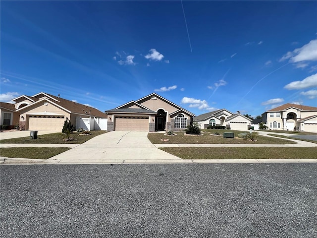 ranch-style house with a garage, driveway, and fence