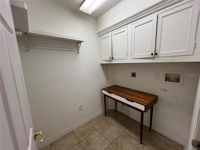 clothes washing area featuring washer hookup, cabinet space, electric dryer hookup, and baseboards