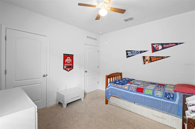 bedroom with a ceiling fan, carpet flooring, and visible vents