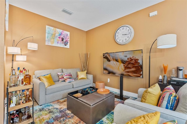 living room with visible vents and baseboards