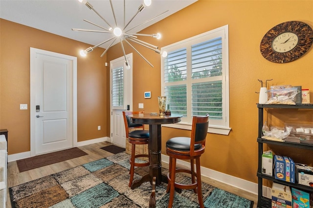 dining space featuring wood finished floors and baseboards