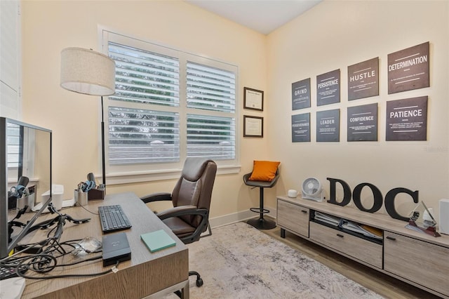 office area featuring baseboards and wood finished floors