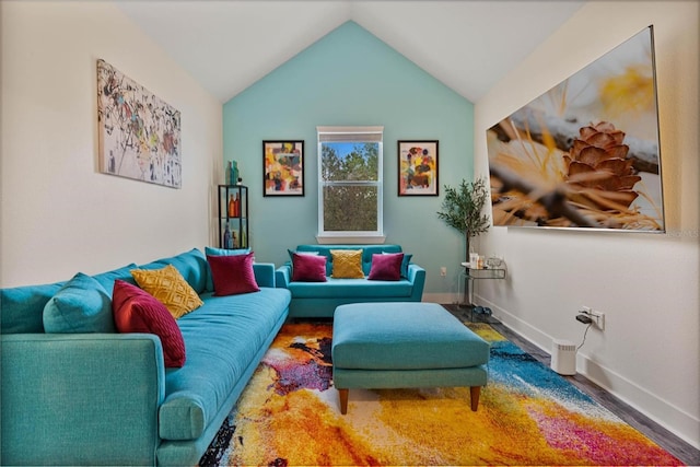 interior space with lofted ceiling, baseboards, and wood finished floors