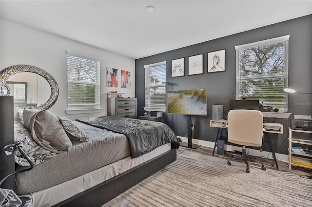 bedroom featuring wood finished floors and baseboards