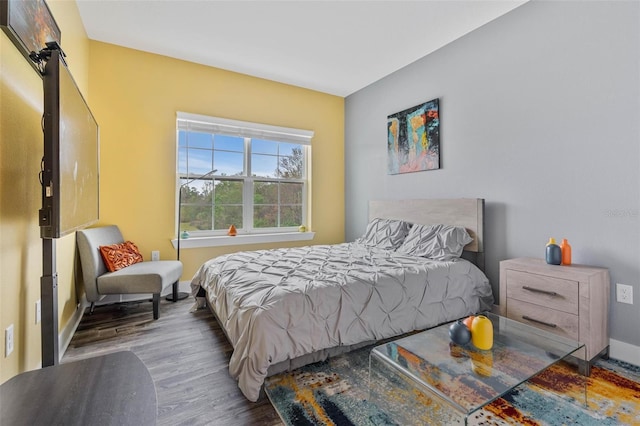 bedroom featuring wood finished floors and baseboards