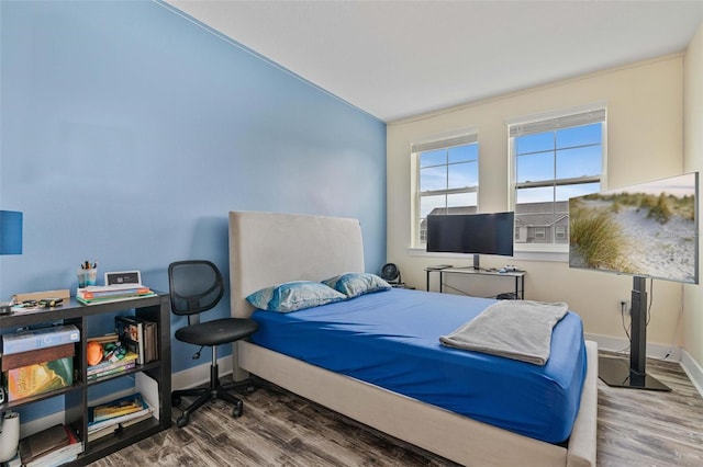 bedroom with baseboards and wood finished floors